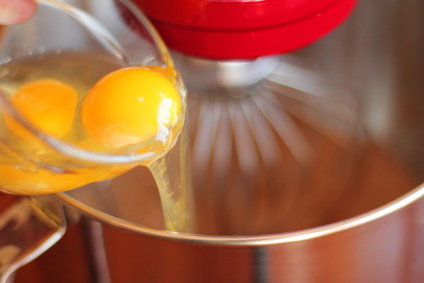 Eggs being Poured into a Mixing Bowl Image of Eggs being Poured into a Mixing Bowl