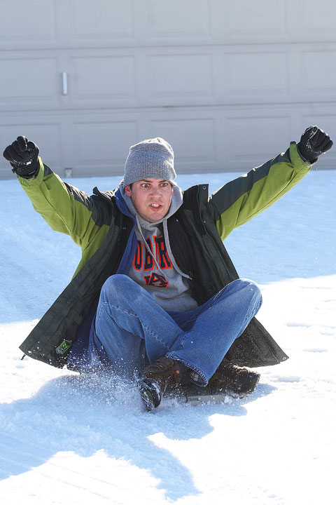 Kevin on His Sled Image of Kevin Sledding in The Snow