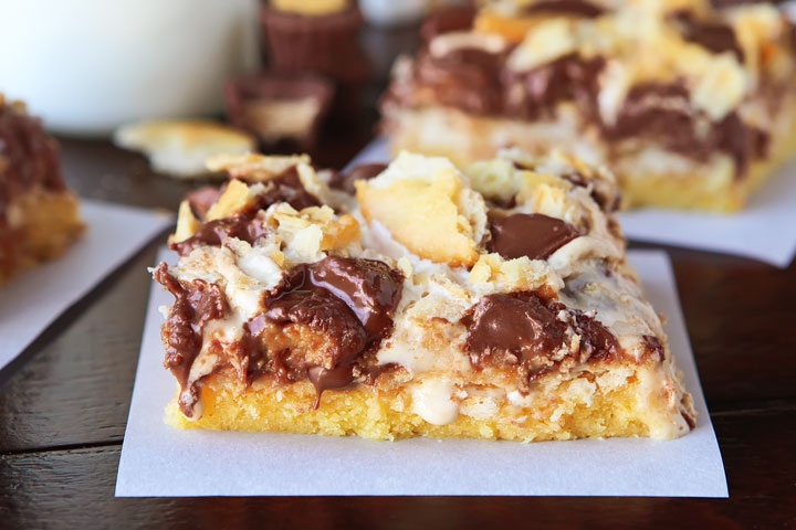 Gooey Ritz Peanut Butter Cup S'mores Bars! Buttery cake topped with marshmallow fluff, mini peanut butter cups and Ritz crackers. If these bars were a person, we'd be married and on our third kid.
