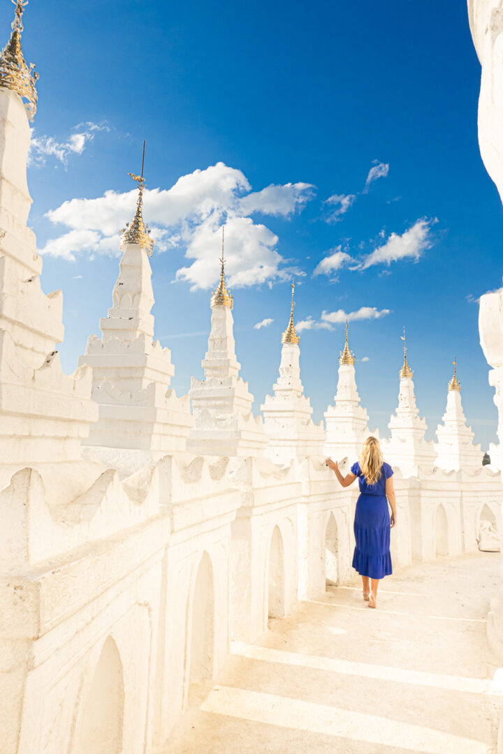 Waking along one of the terraces of the White Temple in Myanmar.